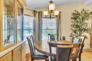 Dining area featuring a chandelier and baseboards