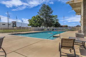 Community pool featuring a patio