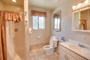 Bathroom with vanity, light tile patterned flooring, and a stall shower