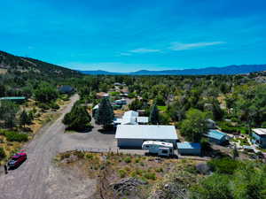 View of subject property with mountains and a forest