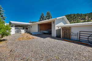 Rear view of house featuring a metal roof and ceiling fan