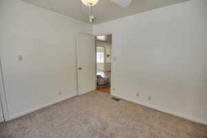 Unfurnished room with carpet and baseboards