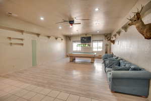 Rec room with pool table, ceiling fan, a textured ceiling, light wood finished floors, and recessed lighting