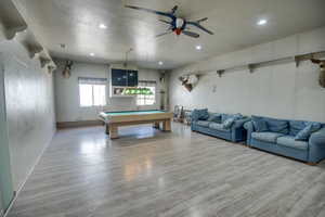 Recreation room with pool table, wood finished floors, a textured ceiling, a ceiling fan, and recessed lighting