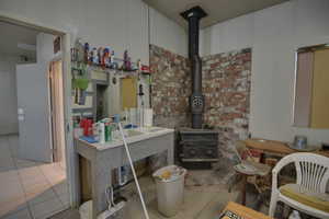 Kitchen featuring a wood stove and tile patterned flooring