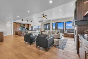 Living room featuring light wood-style flooring, recessed lighting, and a ceiling fan