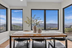 Dining area with a mountain view, light wood-style flooring, healthy amount of natural light, and recessed lighting