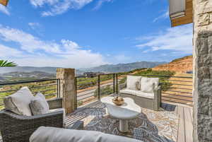 Balcony featuring an outdoor living space and a mountain view