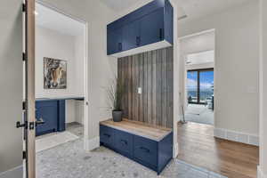 Mudroom featuring a water view, light wood-style flooring, and recessed lighting