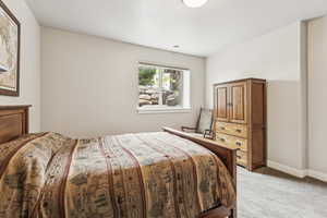 Bedroom with light carpet and baseboards