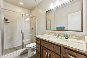 Bathroom featuring vanity, a stall shower, and recessed lighting