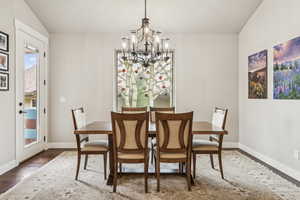 Dining space featuring hardwood / wood-style flooring and a chandelier