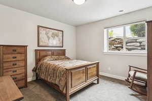 Carpeted bedroom featuring baseboards