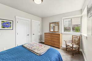 Carpeted bedroom featuring a closet and baseboards