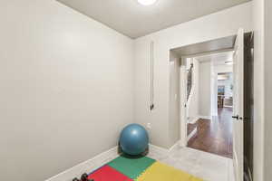 Workout area featuring tile patterned floors and a wall mounted AC