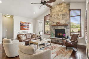 Living area featuring wood-type flooring, a fireplace, high vaulted ceiling, recessed lighting, and a ceiling fan