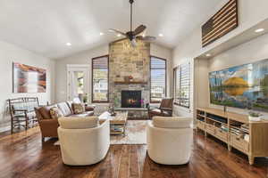 Living area featuring dark wood-style floors, a fireplace, lofted ceiling, recessed lighting, and a ceiling fan