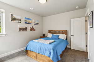 Bedroom with carpet flooring and baseboards