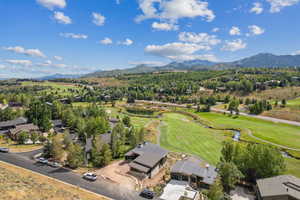 Aerial perspective of suburban area featuring mountains and a golf club