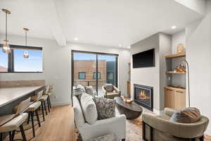 Within the great room sits this cozy family room with its warm fireplace, mounted T.V. and built-ins.