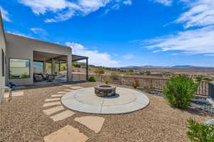 View of patio with an outdoor fire pit and a mountain view