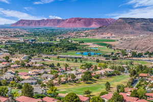 Aerial perspective of suburban area featuring a golf club and a water and mountain view