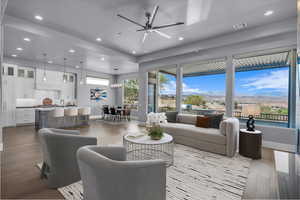 Living room with recessed lighting, dark wood finished floors, ceiling fan, and a mountain view