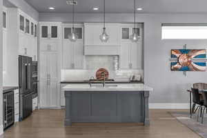 Kitchen with gray cabinets, backsplash, pendant lighting, and recessed lighting