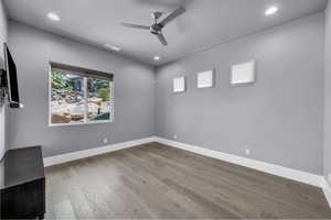 Spare room featuring light wood finished floors, a ceiling fan, and recessed lighting