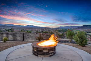 Patio terrace at dusk with a mountain view, a fire pit, and a patio