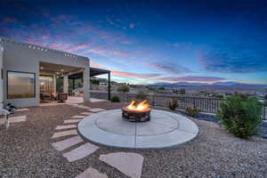 Yard at dusk featuring a patio, an outdoor fire pit, and a mountain view