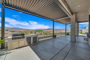 View of patio / terrace with a mountain view and exterior kitchen