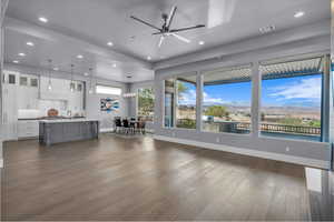 Living room featuring dark wood-style floors, recessed lighting, a ceiling fan, and a mountain view