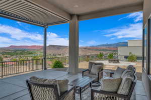 Balcony with an outdoor living space with a fire pit and a mountain view