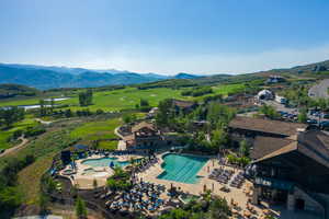 Drone / aerial view of a water and mountain view and a local golf course