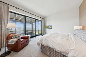 Carpeted bedroom featuring access to outside and a mountain view