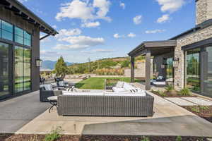 View of patio / terrace featuring an outdoor hangout area and a mountain view