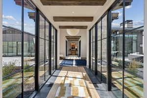 Hall with beam ceiling and expansive windows