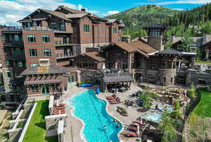 Community pool with a patio and a mountain view