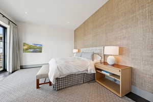 Bedroom with wallpapered walls, access to outside, and recessed lighting