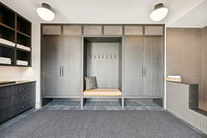 Mudroom featuring dark tile patterned flooring