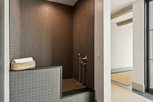Full bathroom with walk in shower and tile patterned flooring