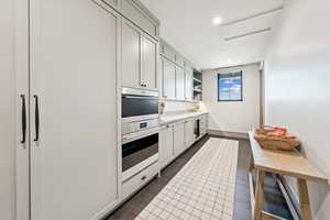 Kitchen featuring open shelves, recessed lighting, stainless steel double oven, dark wood finished floors, and white cabinetry