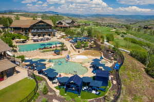 Aerial view of a pool and a mountainous background