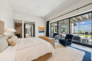 Bedroom featuring access to exterior, multiple windows, wood finished floors, and recessed lighting