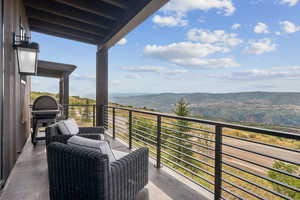 Balcony with a mountain view and area for grilling