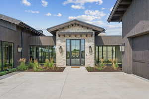 Entrance to property with a patio area and stone siding
