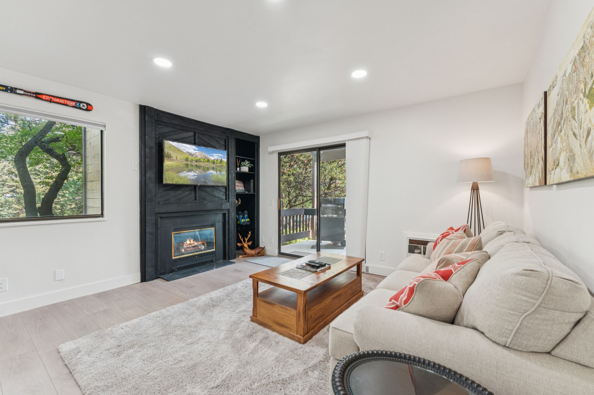 Living area with a fireplace, recessed lighting, and wood finished floors