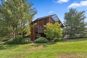 Back of house with a lawn