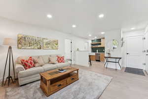 Living area featuring light wood-type flooring and recessed lighting